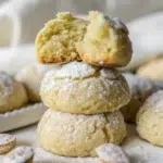 Chewy badam cookies stacked and dusted with powdered sugar