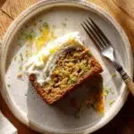 Chocolate-Chip Zucchini Cake with Orange Cream Cheese Frosting 1 Rustic zucchini cake slice with cream cheese frosting and orange zest